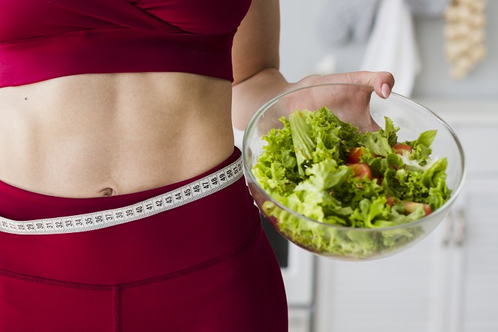 Girls hold the green food for weight loss surgery